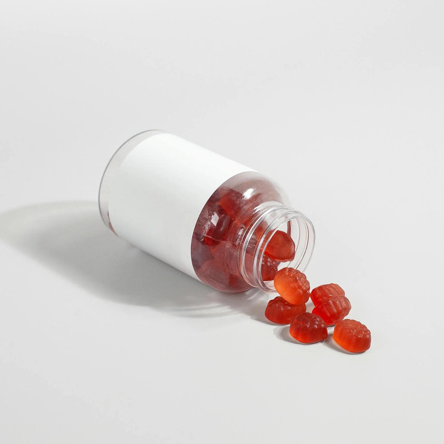 A clear bottle filled with bright red weight loss gummies.