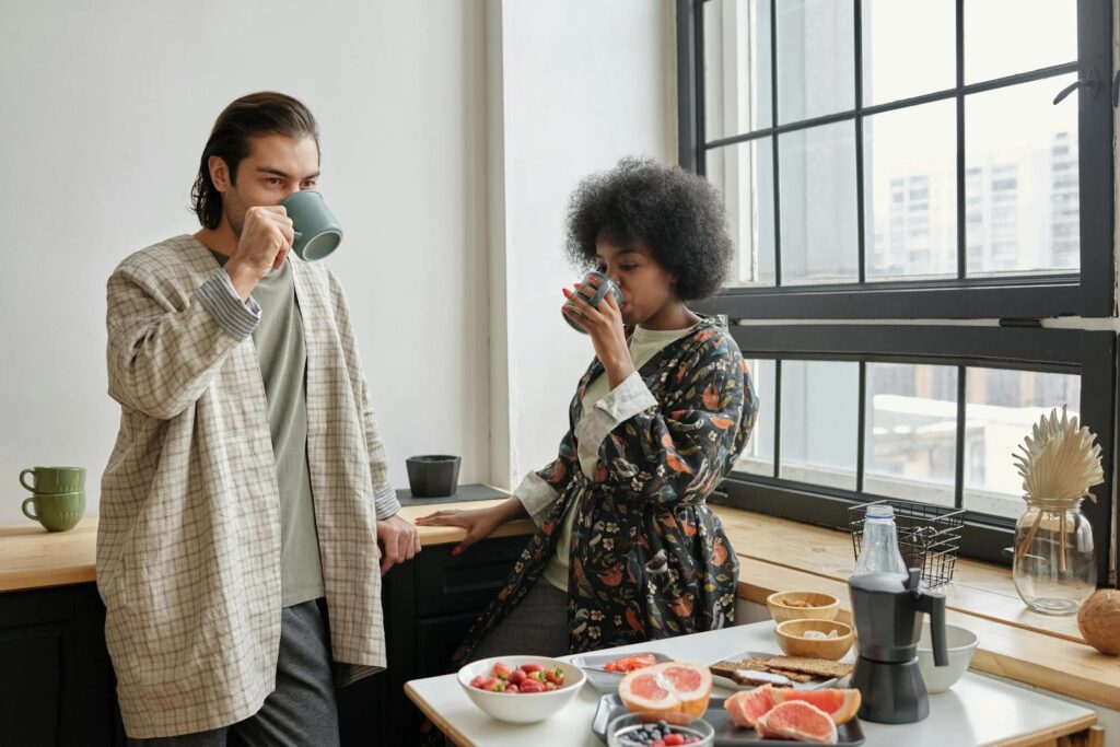 A couple drinking fat-burning coffee in a modern kitchen.
