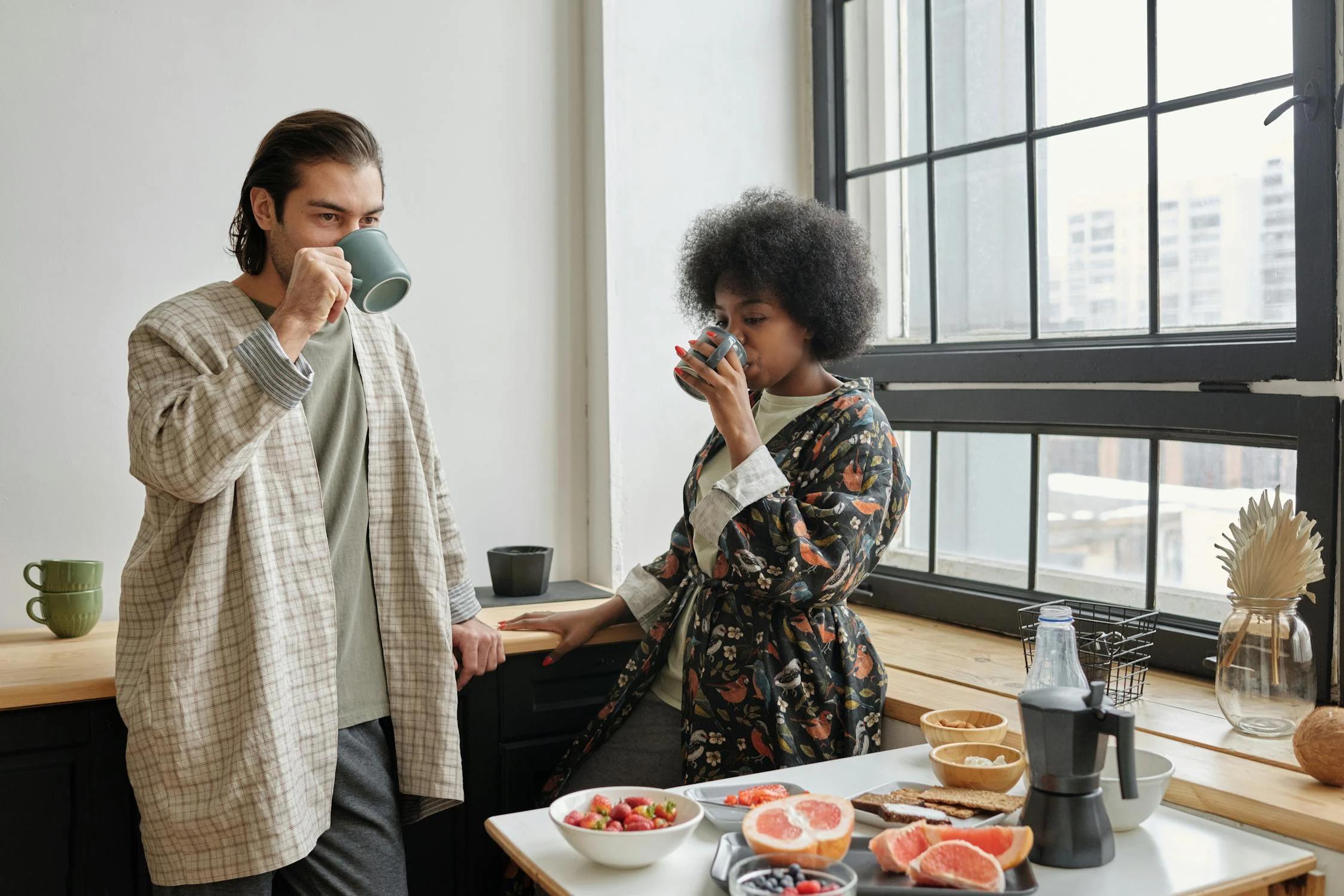 A couple drinking fat-burning coffee in a modern kitchen.