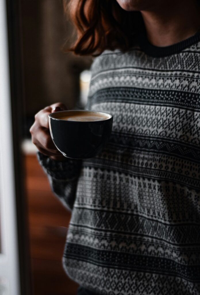 Woman enjoying a morning coffee as part of a fat-burning routine