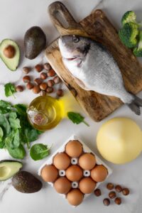 Various foods rich in omega-3 fatty acids, including fish, eggs, avocado, and nuts.