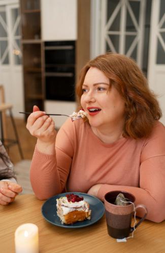 A picture of a woman eating cake