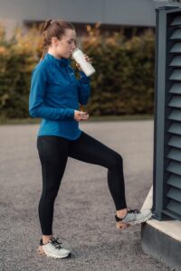 A woman enjoying a cup of coffee, symbolizing natural fat-burning with chlorogenic acid.