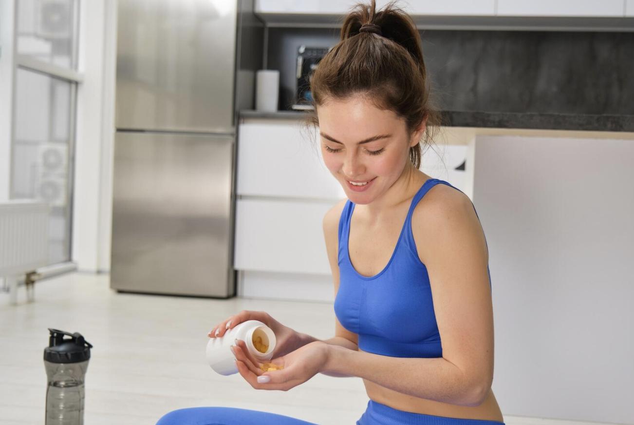 A woman taking thermogenic supplements.